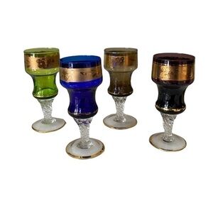 4 Cordial Color Glasses with Gold Trim.  Approx: 4.5” tall 2” base Very pretty